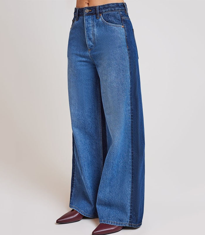 Two-tone paneled denim jeans with asymmetrical design