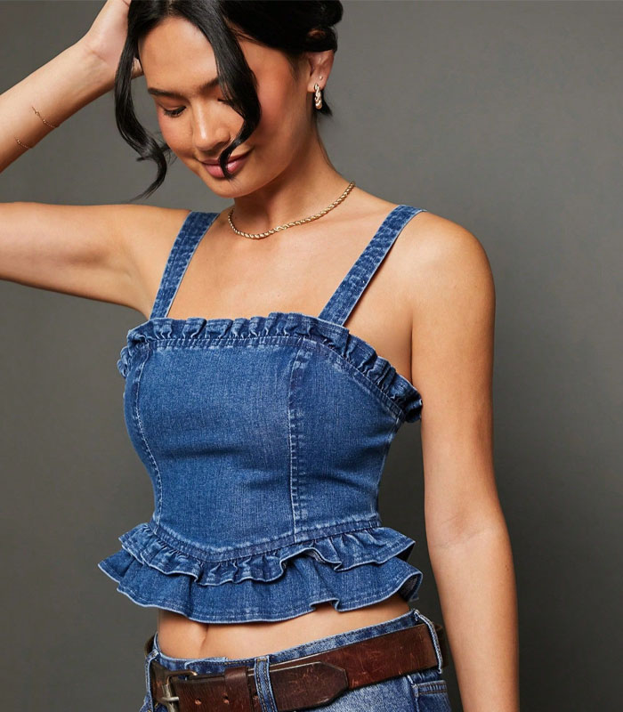 The high-quality cotton-blend denim camisole combines pleated inserts and raw-edge hem for a boho-inspired look